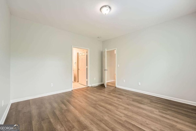 558 Elbridge Dr NW, Atlanta, GA 30318 - unfurnished bedroom with wood finished floors and ensuite bathroom