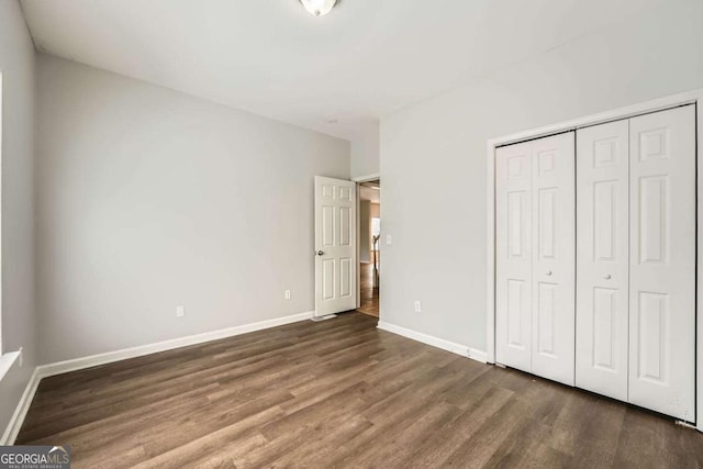 558 Elbridge Dr NW, Atlanta, GA 30318 - unfurnished bedroom with dark wood-type flooring and a closet