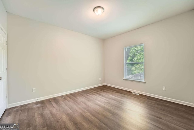 558 Elbridge Dr NW, Atlanta, GA 30318 - spare room featuring dark wood-style flooring