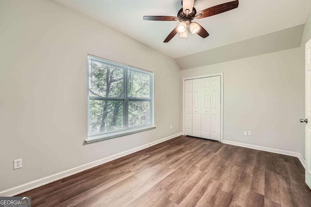 558 Elbridge Dr NW, Atlanta, GA 30318 - unfurnished bedroom with wood finished floors, a closet, vaulted ceiling, and ceiling fan