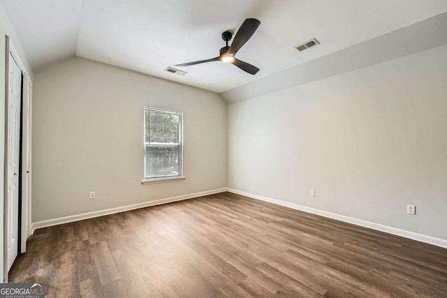 558 Elbridge Dr NW, Atlanta, GA 30318 - unfurnished bedroom featuring vaulted ceiling, dark wood-type flooring, and ceiling fan