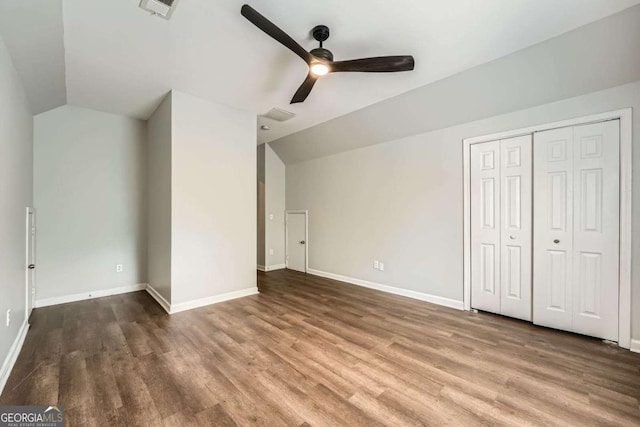 558 Elbridge Dr NW, Atlanta, GA 30318 - unfurnished bedroom featuring vaulted ceiling, wood finished floors, a closet, and ceiling fan