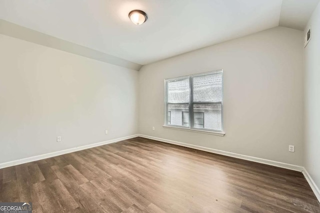 558 Elbridge Dr NW, Atlanta, GA 30318 - spare room with lofted ceiling and dark wood-style flooring