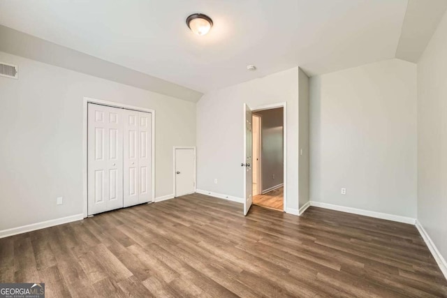 558 Elbridge Dr NW, Atlanta, GA 30318 - unfurnished bedroom with wood finished floors and a closet