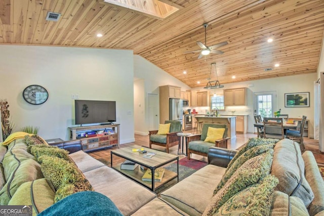 255 S Grove St, Dahlonega, GA 30533 - living room with wood ceiling, vaulted ceiling, light wood-style floors, a skylight, and baseboards