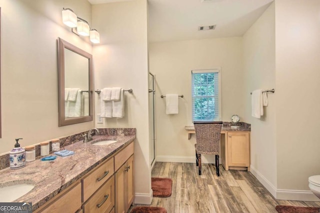 255 S Grove St, Dahlonega, GA 30533 - bathroom with wood finished floors, a shower stall, baseboards, toilet, and double vanity