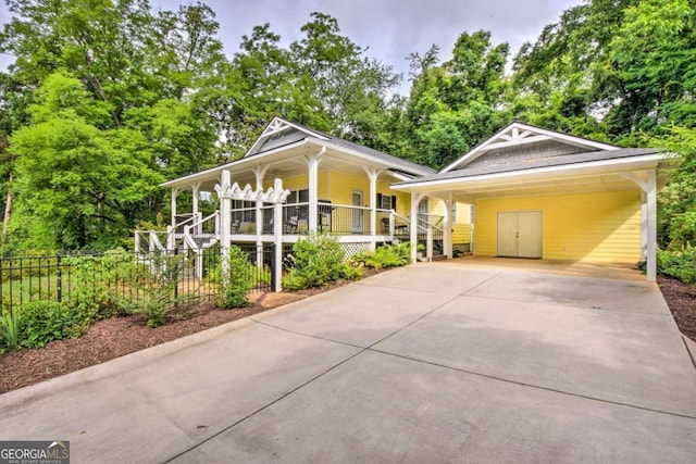 255 S Grove St, Dahlonega, GA 30533 - view of front facade featuring a porch, driveway, fence, an attached carport, and view of scattered trees