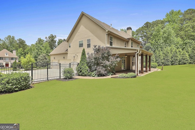 view of home's exterior featuring a chimney, a patio, fence, a garage, and concrete driveway