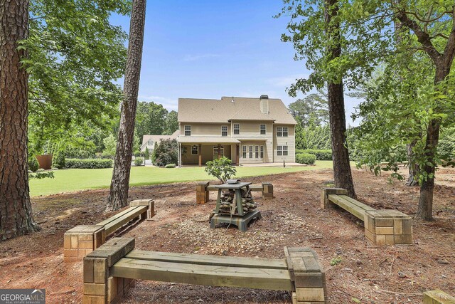 rear view of property with a lawn