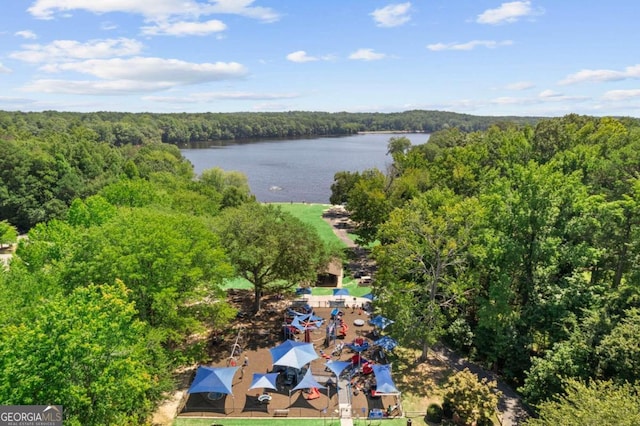 drone / aerial view of a heavily wooded area and a nearby body of water