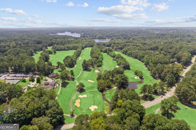 bird's eye view of a nearby body of water, a heavily wooded area, and a golf course