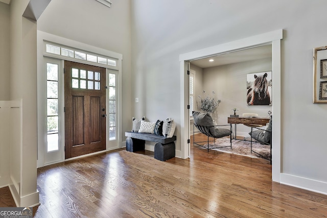 entrance foyer featuring wood finished floors and baseboards