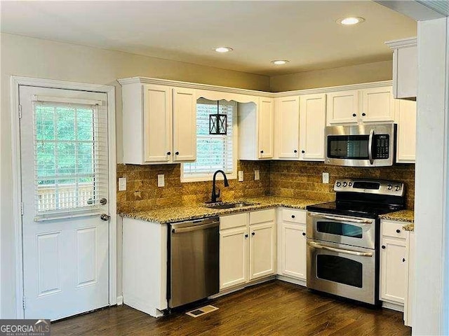 107 Oconnor Dr, Dallas, GA 30157 - kitchen with appliances with stainless steel finishes, a sink, white cabinetry, light stone countertops, and recessed lighting