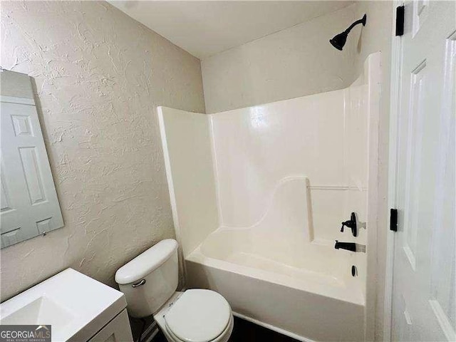 107 Oconnor Dr, Dallas, GA 30157 - bathroom featuring a textured wall, toilet, vanity, and washtub / shower combination