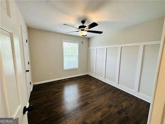 107 Oconnor Dr, Dallas, GA 30157 - unfurnished room with dark wood-type flooring, a ceiling fan, and baseboards