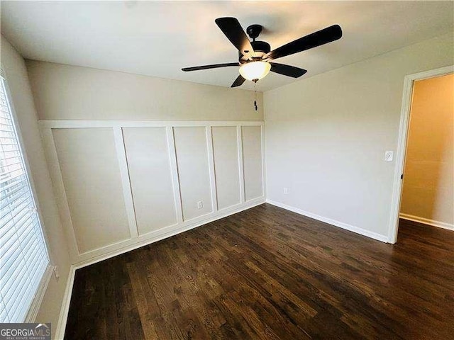 107 Oconnor Dr, Dallas, GA 30157 - unfurnished bedroom with dark wood-style floors, multiple windows, baseboards, and ceiling fan