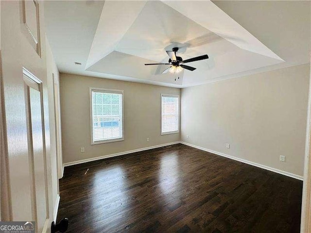 107 Oconnor Dr, Dallas, GA 30157 - spare room with a raised ceiling, wood finished floors, a ceiling fan, and baseboards