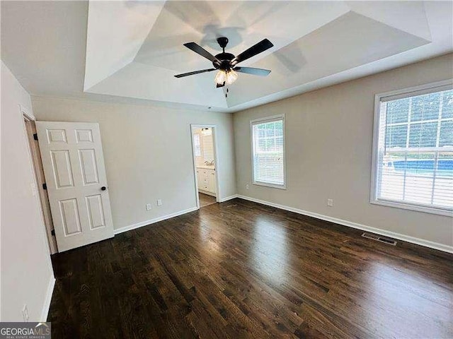 107 Oconnor Dr, Dallas, GA 30157 - unfurnished bedroom with a tray ceiling, wood finished floors, baseboards, and connected bathroom