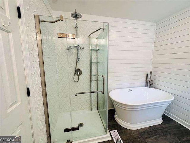 107 Oconnor Dr, Dallas, GA 30157 - bathroom with a shower stall, a freestanding bath, and wood finished floors