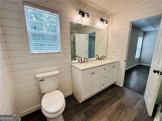 107 Oconnor Dr, Dallas, GA 30157 - full bath featuring wood finished floors, wood walls, double vanity, and toilet