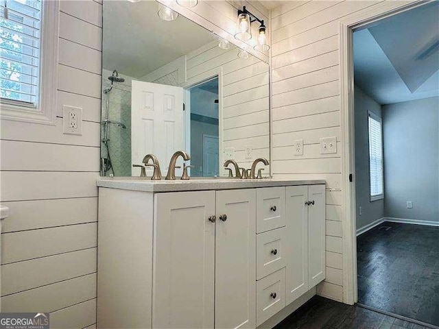 107 Oconnor Dr, Dallas, GA 30157 - bathroom with wood finished floors, wooden walls, double vanity, baseboards, and a shower