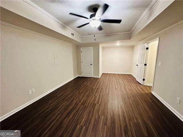 107 Oconnor Dr, Dallas, GA 30157 - spare room featuring a raised ceiling, dark wood-style flooring, ceiling fan, baseboards, and ornamental molding