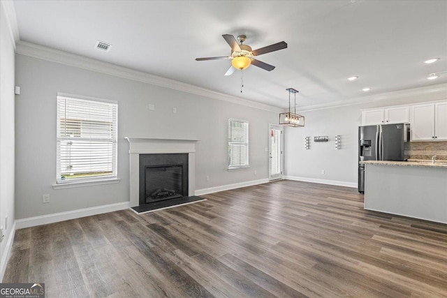 360 Turtle Creek Dr, Winder, GA 30680 - unfurnished living room with ornamental molding, ceiling fan, dark wood-style floors, a fireplace with raised hearth, and baseboards