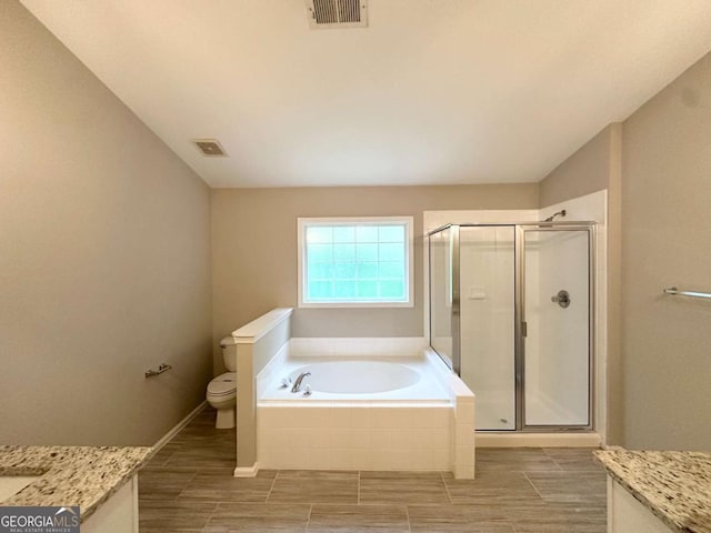 full bath with a garden tub, a shower stall, toilet, vanity, and wood finish floors