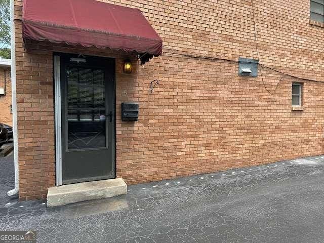 1233 Woodland Ave NE Unit 5, Atlanta, GA 30324 - view of exterior entry featuring brick siding