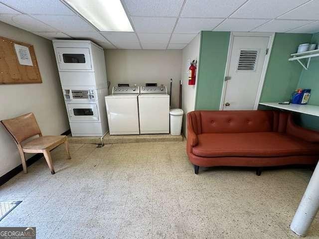 1233 Woodland Ave NE Unit 5, Atlanta, GA 30324 - laundry area featuring estacked washer and dryer, light floors, and washer and dryer