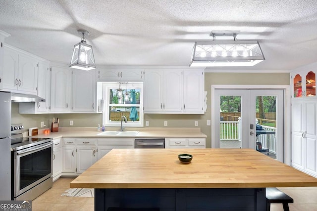 109 Mackqueen Dr, Brunswick, GA 31525 - kitchen featuring appliances with stainless steel finishes, a sink, under cabinet range hood, white cabinetry, and french doors