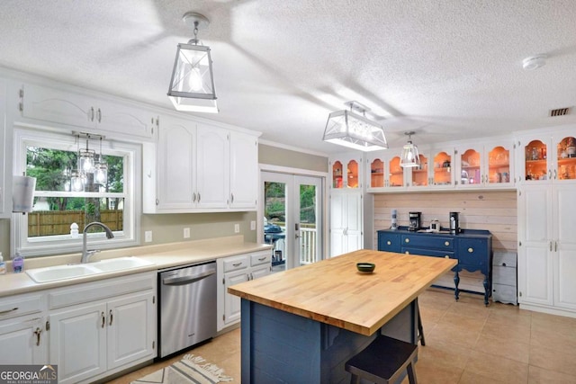 109 Mackqueen Dr, Brunswick, GA 31525 - kitchen featuring stainless steel dishwasher, a sink, white cabinets, wood counters, and glass insert cabinets