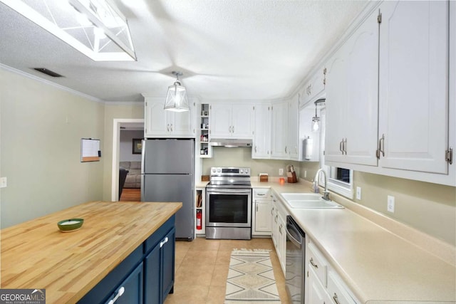 109 Mackqueen Dr, Brunswick, GA 31525 - kitchen with stainless steel appliances, blue cabinetry, under cabinet range hood, white cabinetry, and a sink