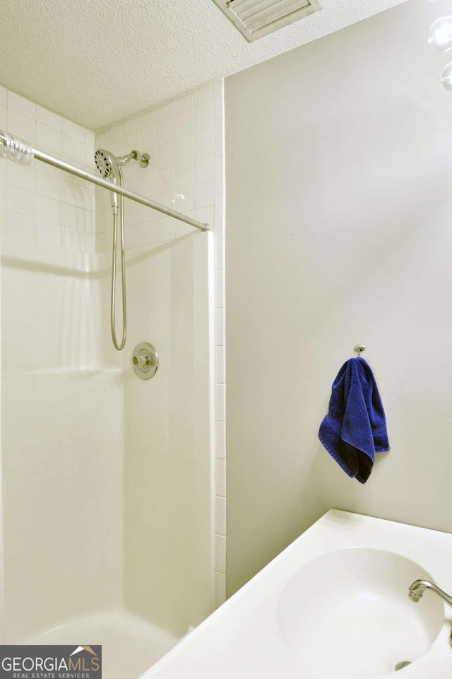 109 Mackqueen Dr, Brunswick, GA 31525 - full bath featuring a textured ceiling, a shower, and a sink