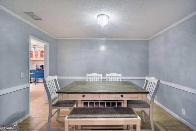 109 Mackqueen Dr, Brunswick, GA 31525 - dining area featuring ornamental molding, a textured ceiling, and tile patterned floors