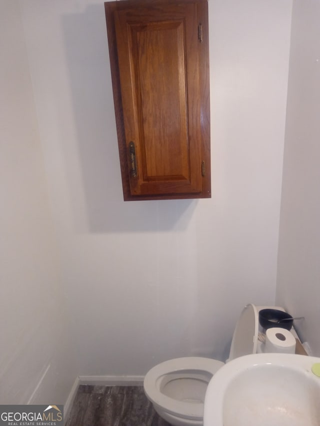 1105 Oak Knoll Ter SE, Atlanta, GA 30315 - bathroom featuring a sink, baseboards, wood finished floors, and toilet
