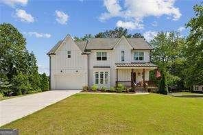 3617 Carson Ln SE, Smyrna, GA 30080 - view of front facade featuring concrete driveway, a front lawn, a garage, and a porch