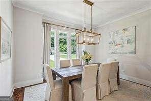 3617 Carson Ln SE, Smyrna, GA 30080 - dining room with a chandelier, ornamental molding, and baseboards