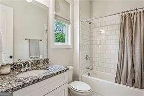 3617 Carson Ln SE, Smyrna, GA 30080 - bathroom featuring vanity, toilet, and shower / bath combo