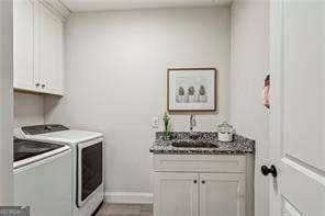 3617 Carson Ln SE, Smyrna, GA 30080 - laundry room with washer and clothes dryer, cabinet space, and baseboards