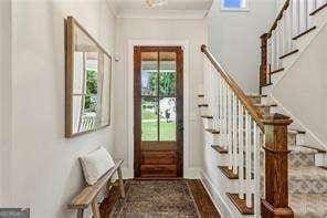 3617 Carson Ln SE, Smyrna, GA 30080 - doorway to outside with stairs, crown molding, and baseboards
