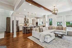 3617 Carson Ln SE, Smyrna, GA 30080 - living area featuring a chandelier, dark wood-style floors, beamed ceiling, recessed lighting, and ornamental molding