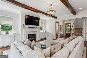 3617 Carson Ln SE, Smyrna, GA 30080 - living room with stairs, beamed ceiling, plenty of natural light, and a fireplace