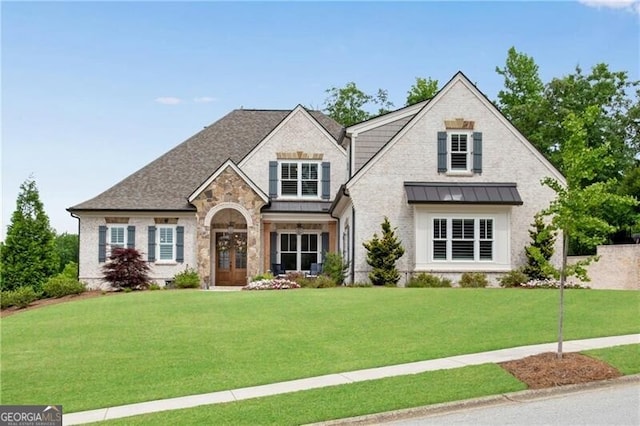 5844 Yoshino Cherry Ln, Braselton, GA 30517 - view of front of home featuring a standing seam roof, a front yard, stone siding, and metal roof