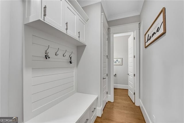 5844 Yoshino Cherry Ln, Braselton, GA 30517 - mudroom featuring light wood finished floors, baseboards, and ornamental molding