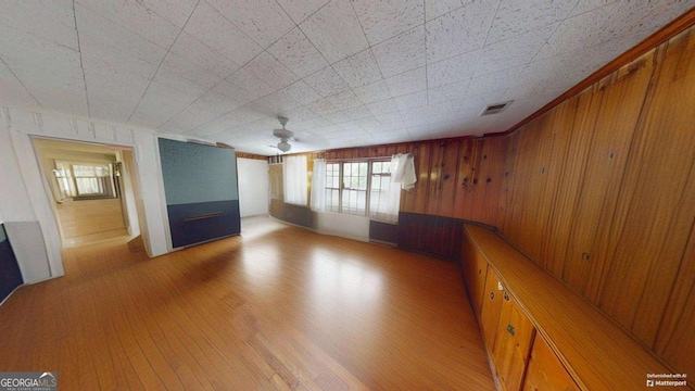 2422 Williams Mill Rd, Zebulon, GA 30295 - unfurnished living room featuring a ceiling fan, wood finished floors, and wooden walls