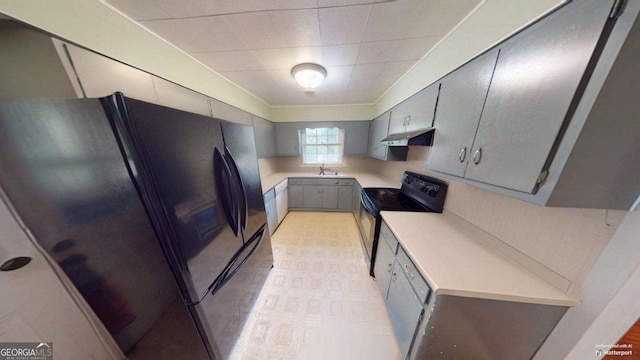 2422 Williams Mill Rd, Zebulon, GA 30295 - kitchen with black appliances, gray cabinetry, under cabinet range hood, light countertops, and a sink