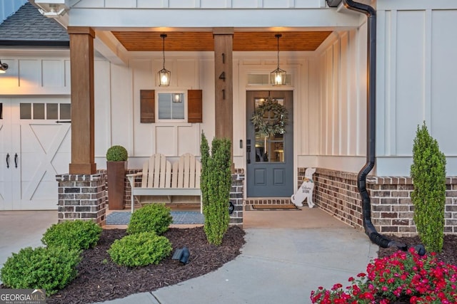 141 Alaina Rd, Canton, GA 30115 - property entrance with board and batten siding, covered porch, and a shingled roof