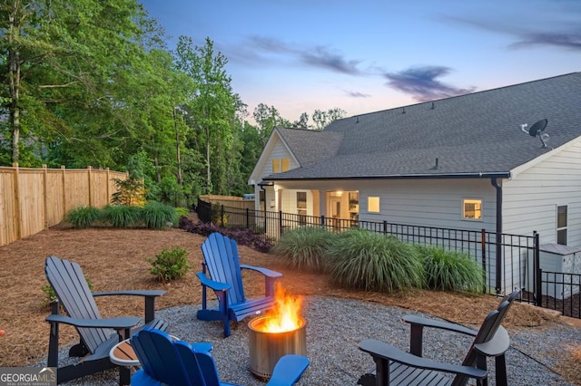 141 Alaina Rd, Canton, GA 30115 - patio terrace at dusk featuring an outdoor fire pit, a fenced backyard, and a patio area