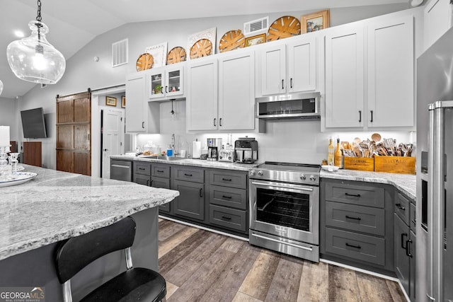 2109 Brewers Mill Rd, Elberton, GA 30635 - kitchen with stainless steel appliances, gray cabinets, lofted ceiling, decorative light fixtures, and dark wood-style flooring